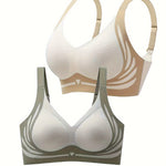 Two bras, one beige and one green, on a white background