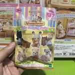Sylvanian Families Baby Shopping Series packaging held by a hand on a green surface.