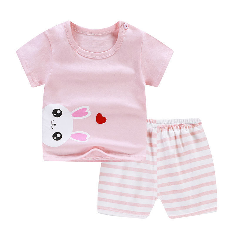 Children's pink outfit with bunny design and striped shorts on a white background
