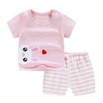 Children's pink outfit with bunny design and striped shorts on a white background