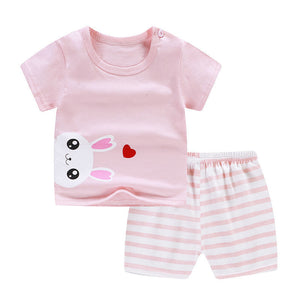 Children's pink outfit with bunny design and striped shorts on a white background