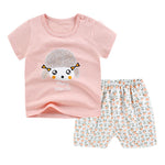 Children's outfit with pink shirt and patterned pants on a white background