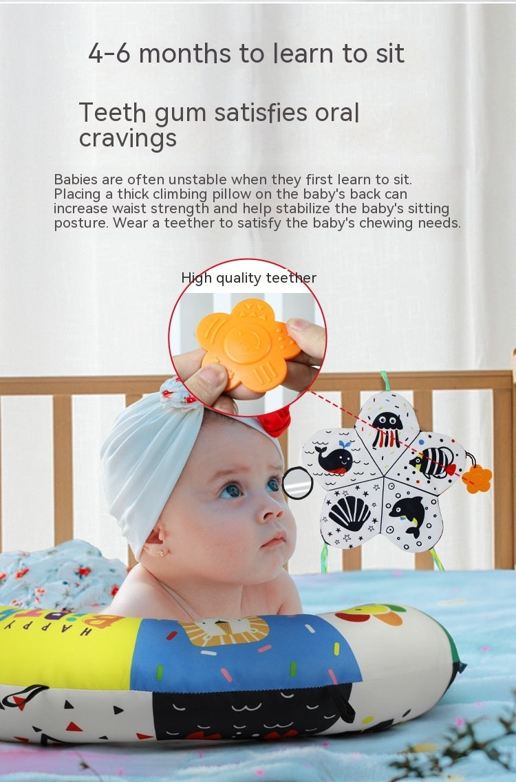 Baby with a teething ring and educational toys on a crib