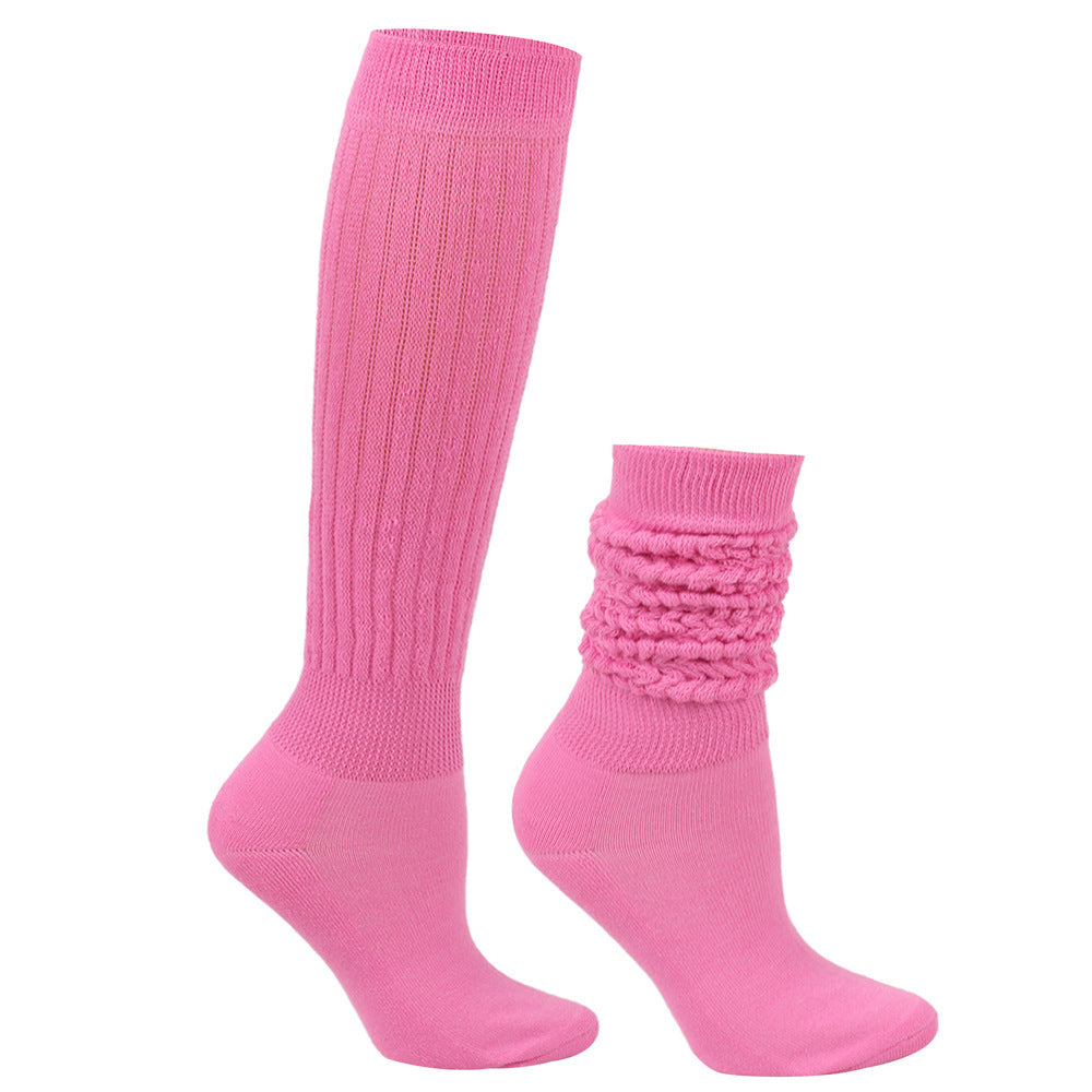 Two pink socks, one knee-high and one sock with textured top, on a white background.