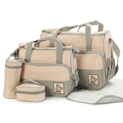 Set of beige and gray diaper bags with matching pouches on a white background