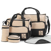 Set of bags including a large duffel bag, smaller pouches, and a travel mat on a white background.
