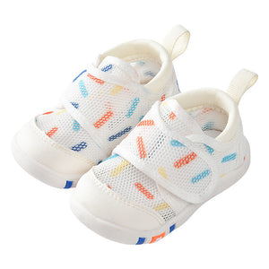 White children's sneakers with colorful patterns on a white background