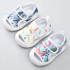 Three pairs of children's sandals with different designs on a light gray background