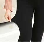 Black leggings worn by a person with a blurred background