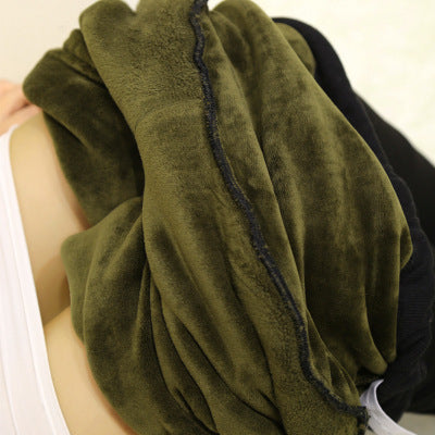 Green towel or fabric held by a person with a neutral background
