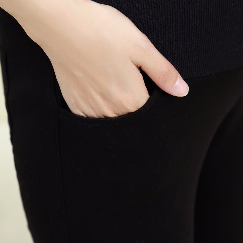 Person wearing black pants with a hand in the pocket