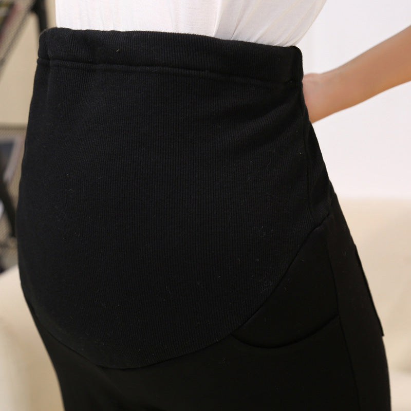 Black skirt worn by a person on a blurred background