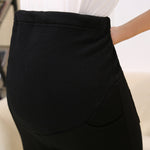 Black skirt worn by a person on a blurred background