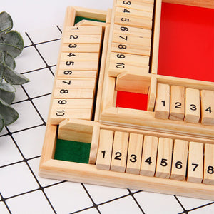 Wooden number blocks with red and green sections on a white and black grid background