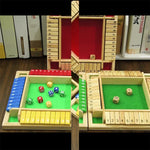 Wooden dice game set with dice and numbered slots on a green board.
