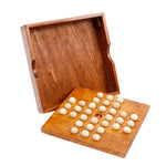 Wooden game board with white pieces and open wooden box on a white background